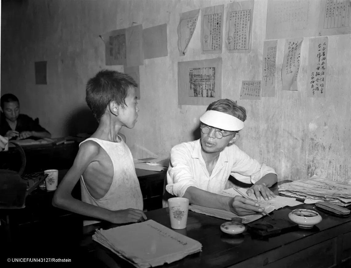 In 1946 in China, a homeless child rescued from the streets in the town of Hengyang, in the south-eastern province of Hunan, gives his name and former address to a clerk in one of the eight UNRRA shelters for famine refugees.