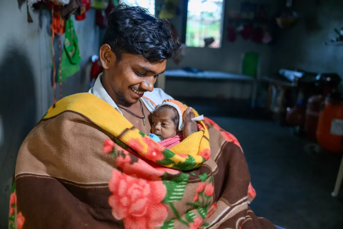 A father warming his son through skin-to-skin contact in Gujarat as per the Kangaroo Mother Care (KMC) practice
