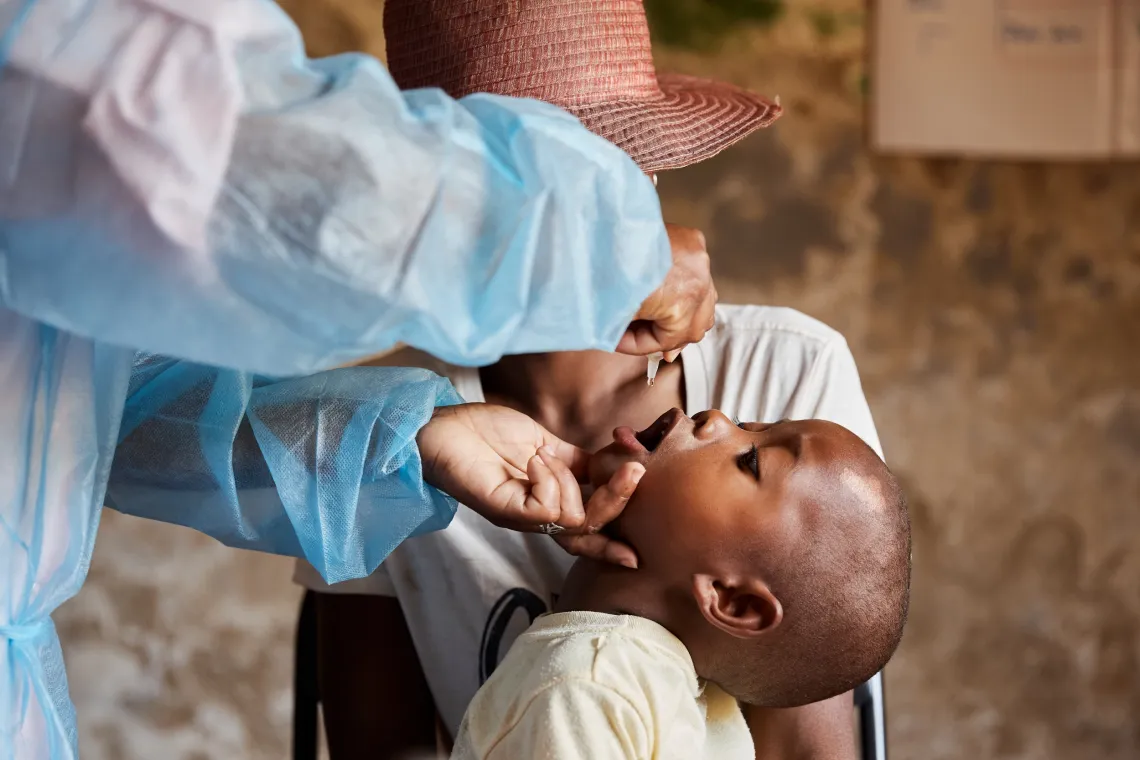 A boy receives an oral polio dose