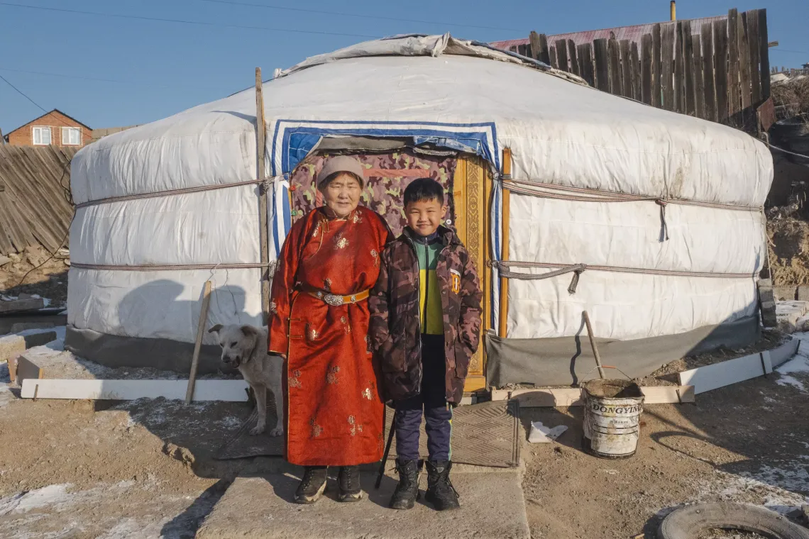 Grandmother Dulmaa Batochir and her grandson, Bayan Erdene Munkh Ochir, 8, stand in front of their ger in Ulaanbaatar&rsquo;s Bayanzurkh district. 