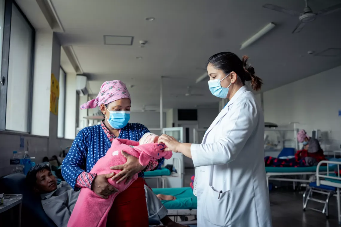 Dr. Smriti Poudel counselling new mother Sarita Khatri Tamang at the Paropakar Maternity and Women's Hospital in Kathmandu.