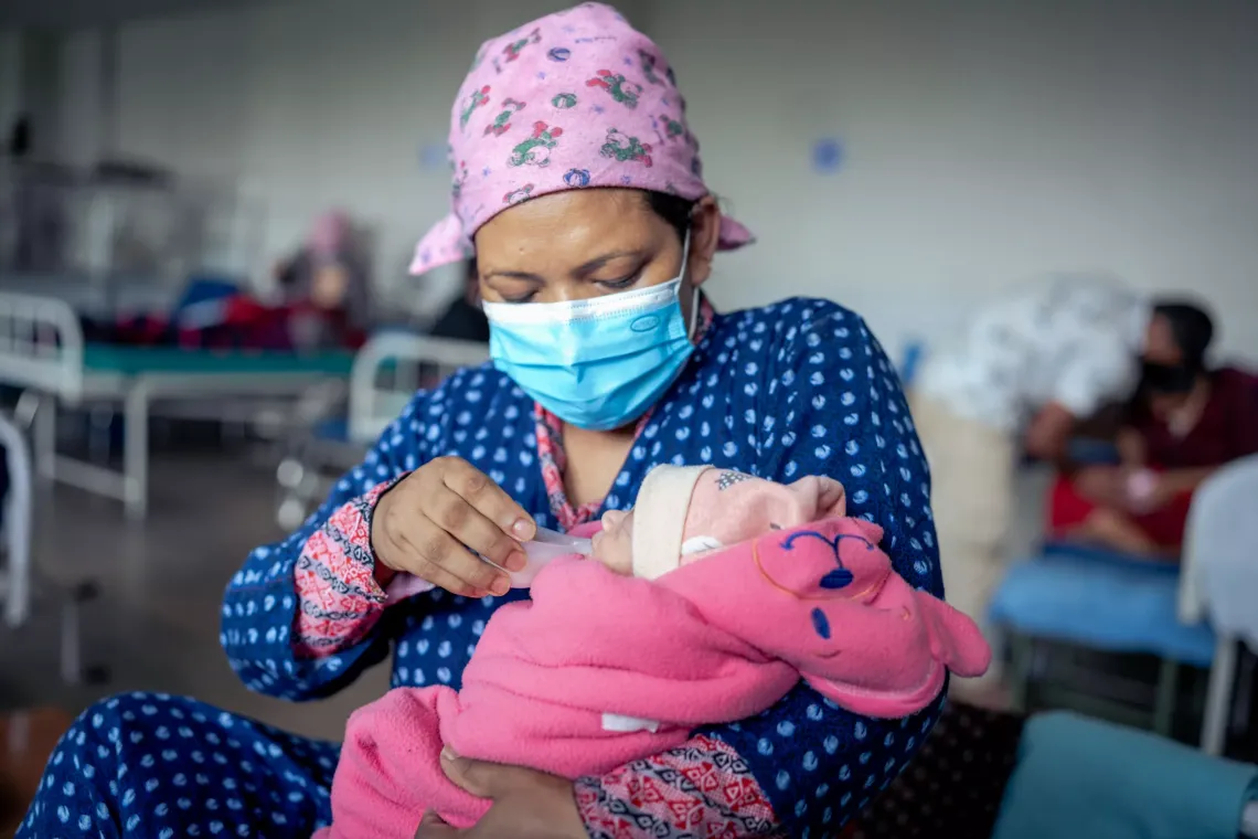 New mother Sarita Khatri Tamang feeds milk to her newborn