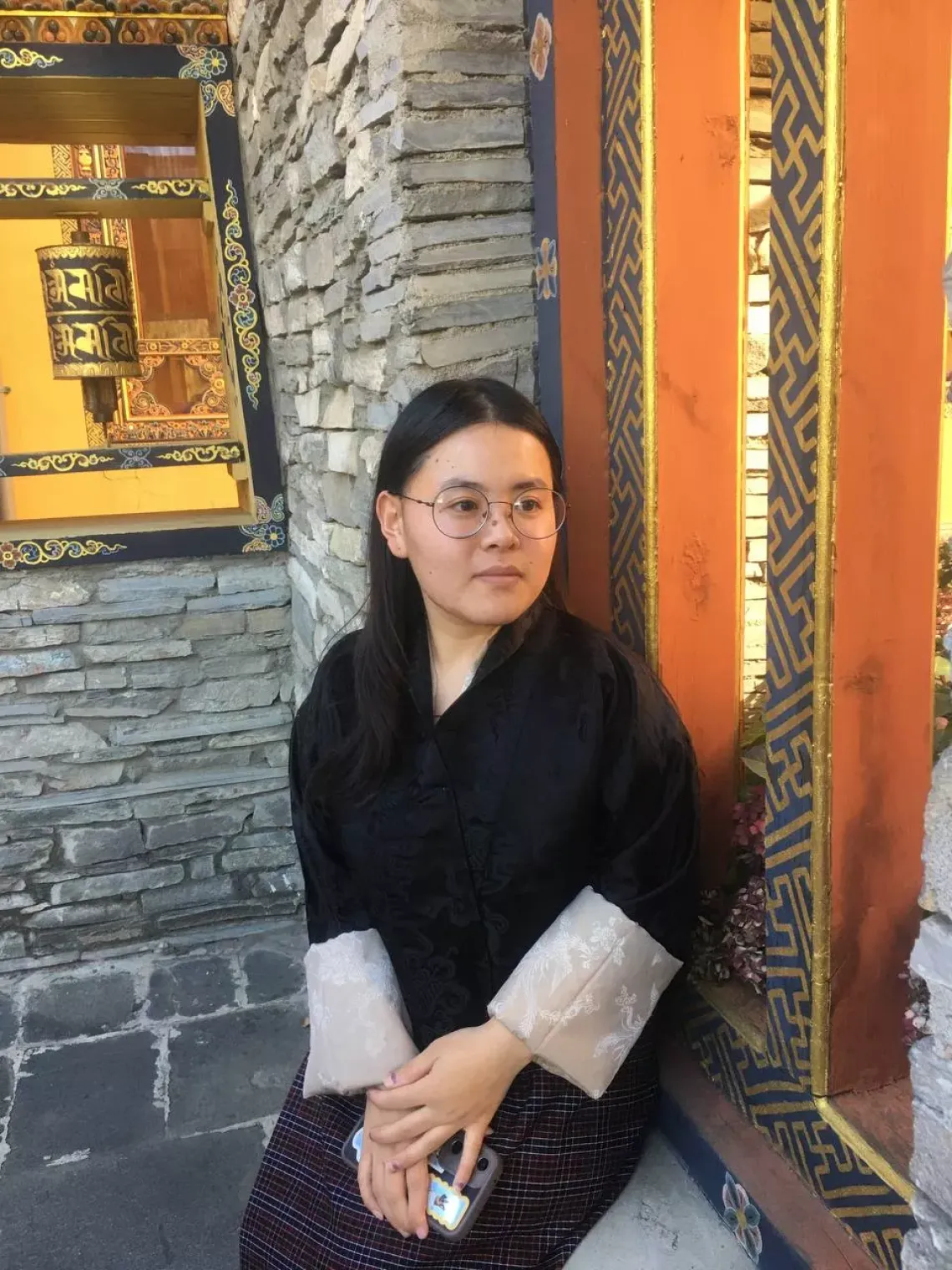 Tshering sits by the window 