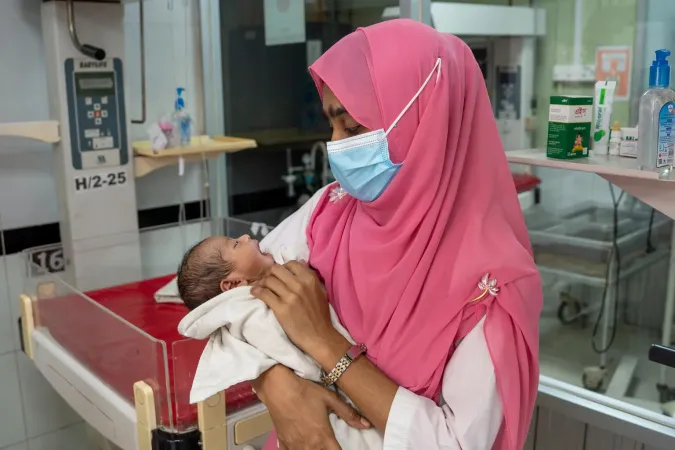 A nurse cradles a crying newborn at the SCANU unit of Cox&rsquo;s Bazar District Sadar Hospital.