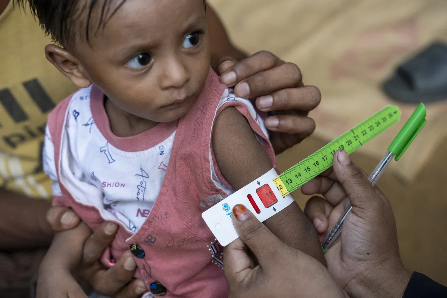 Aziz Khan (12 months) is screened by community nutrition volunteer Shafiqa in the Rohingya refugee camp in Cox&rsquo;s Bazar. 