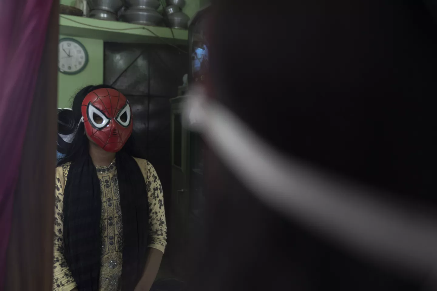 A girl wearing spider man mask 
