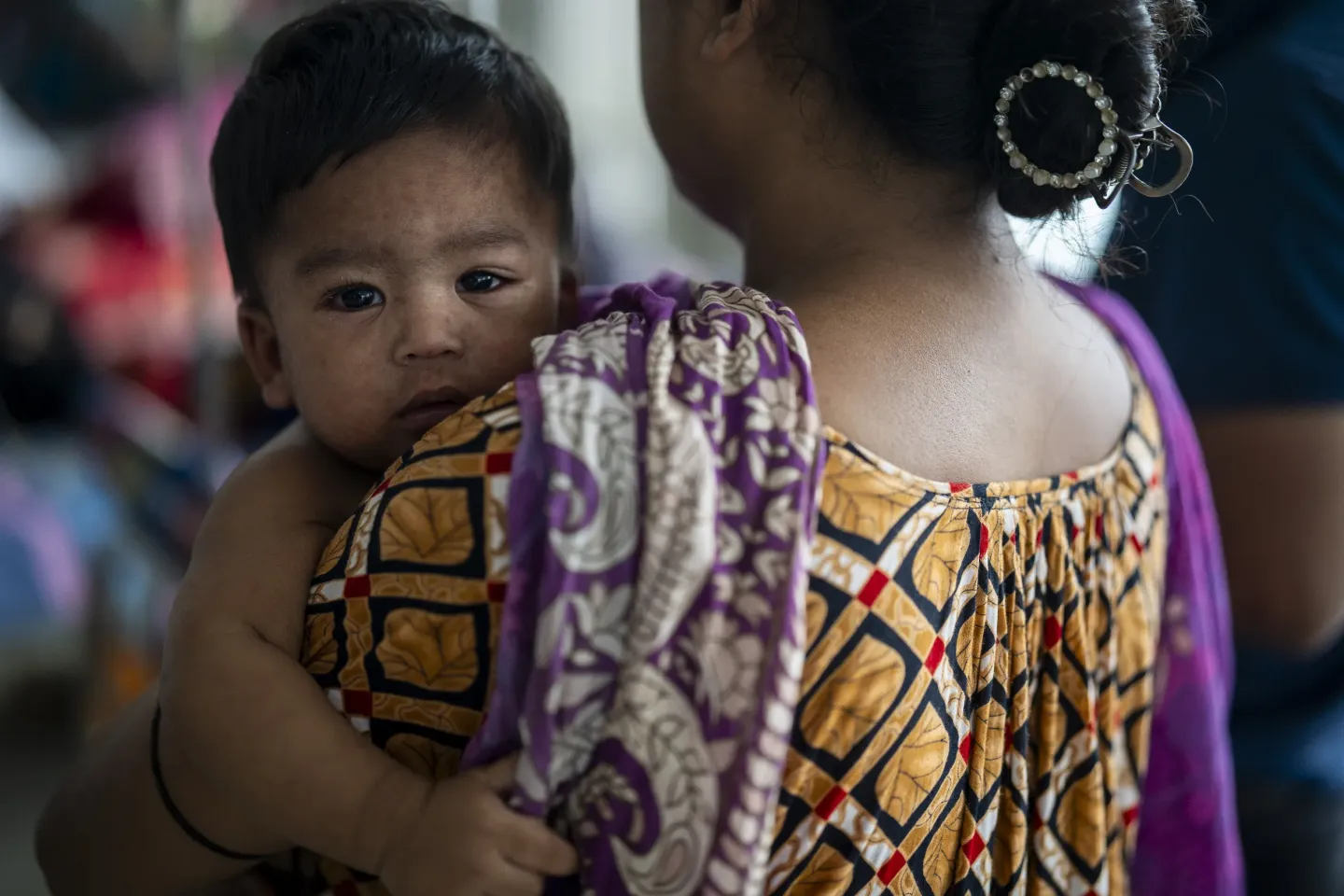 Ten-month-old Riyangshu sits quietly on his mother&rsquo;s lap in the measles ward at Mohakhali&rsquo;s DNCC Hospital