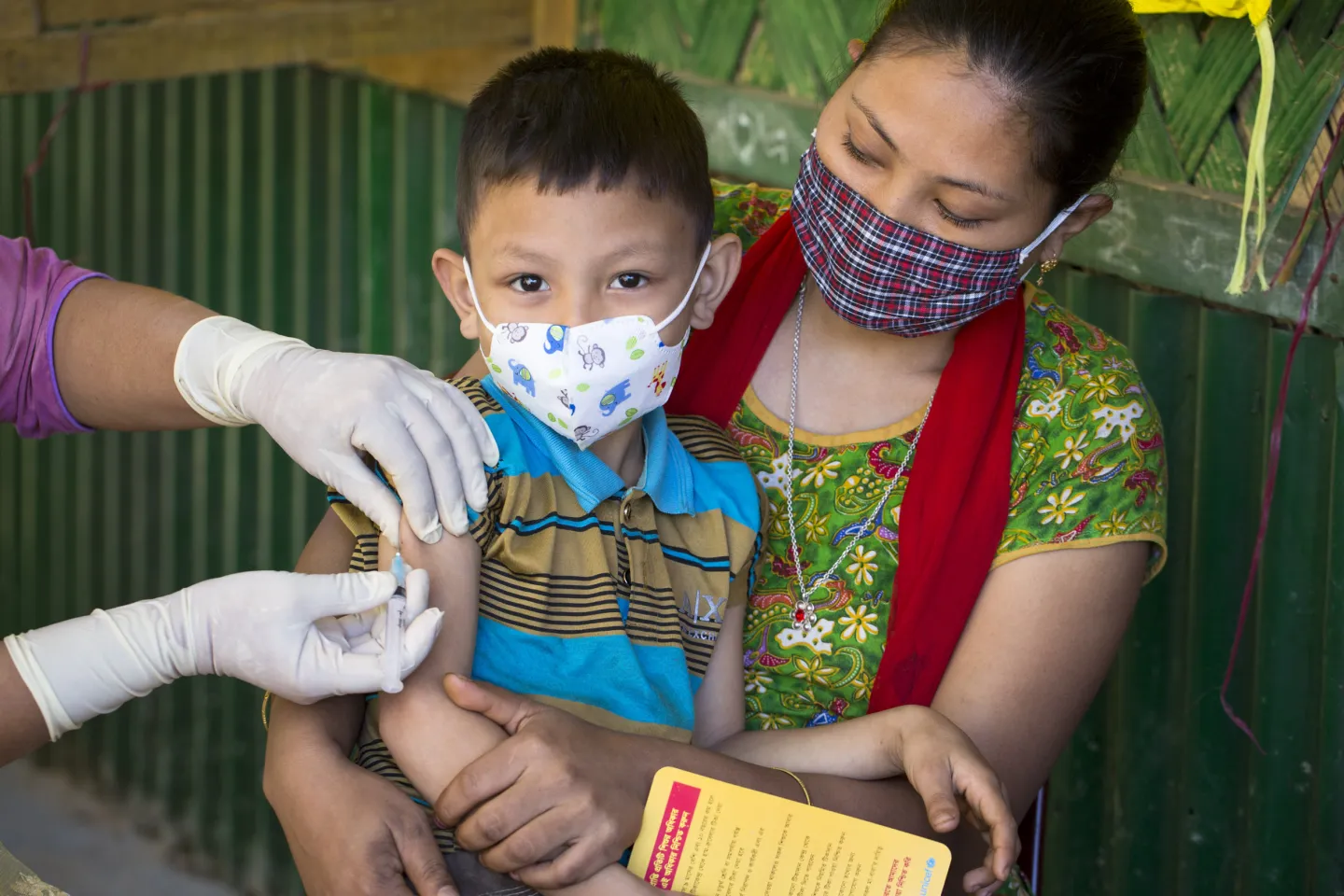 Bisakha Chakma brings her youngest son Tuhin Marma (7) for a measles-rubella vaccination in Rangamati during the national vaccination campaign. 