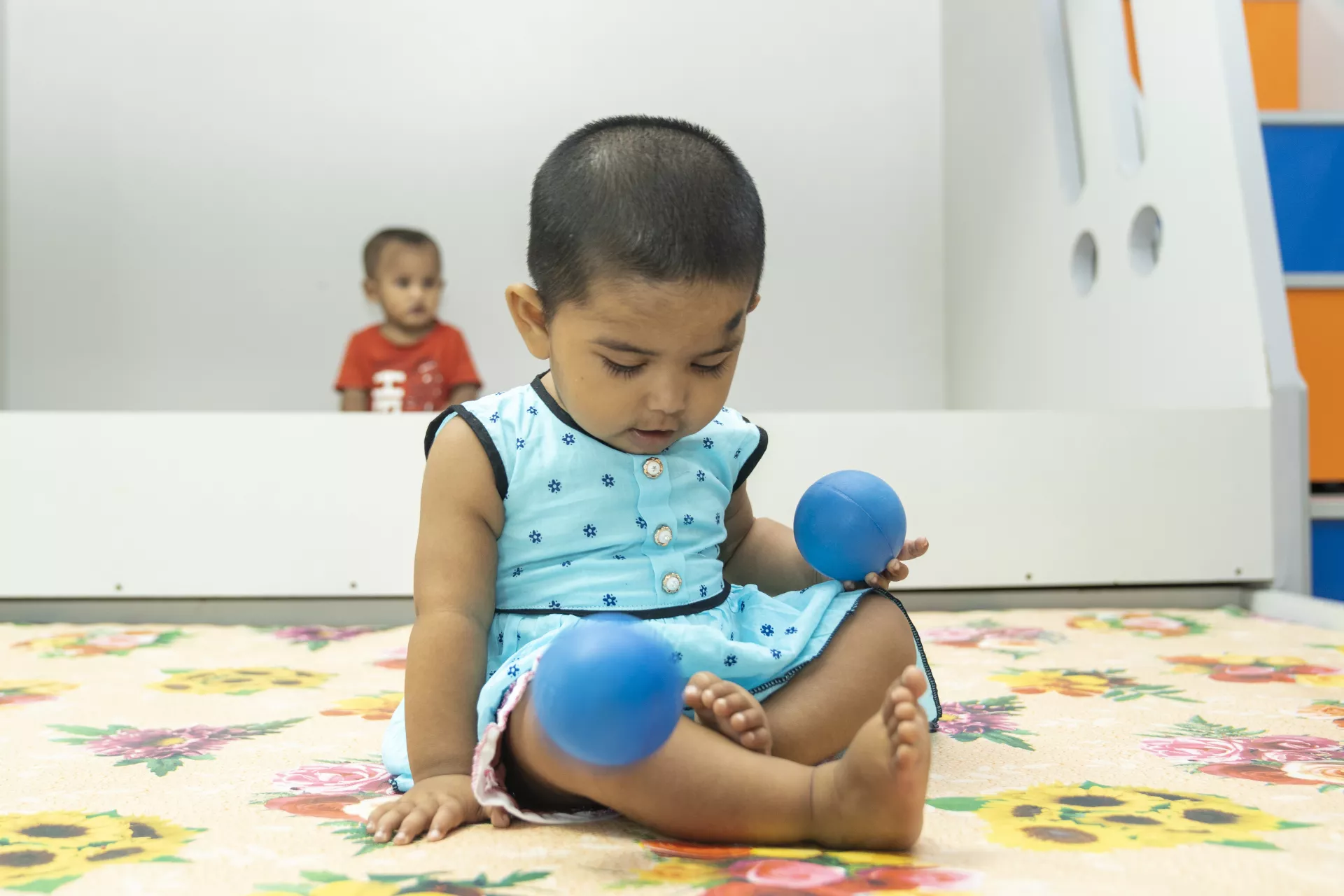A baby playing with toys 