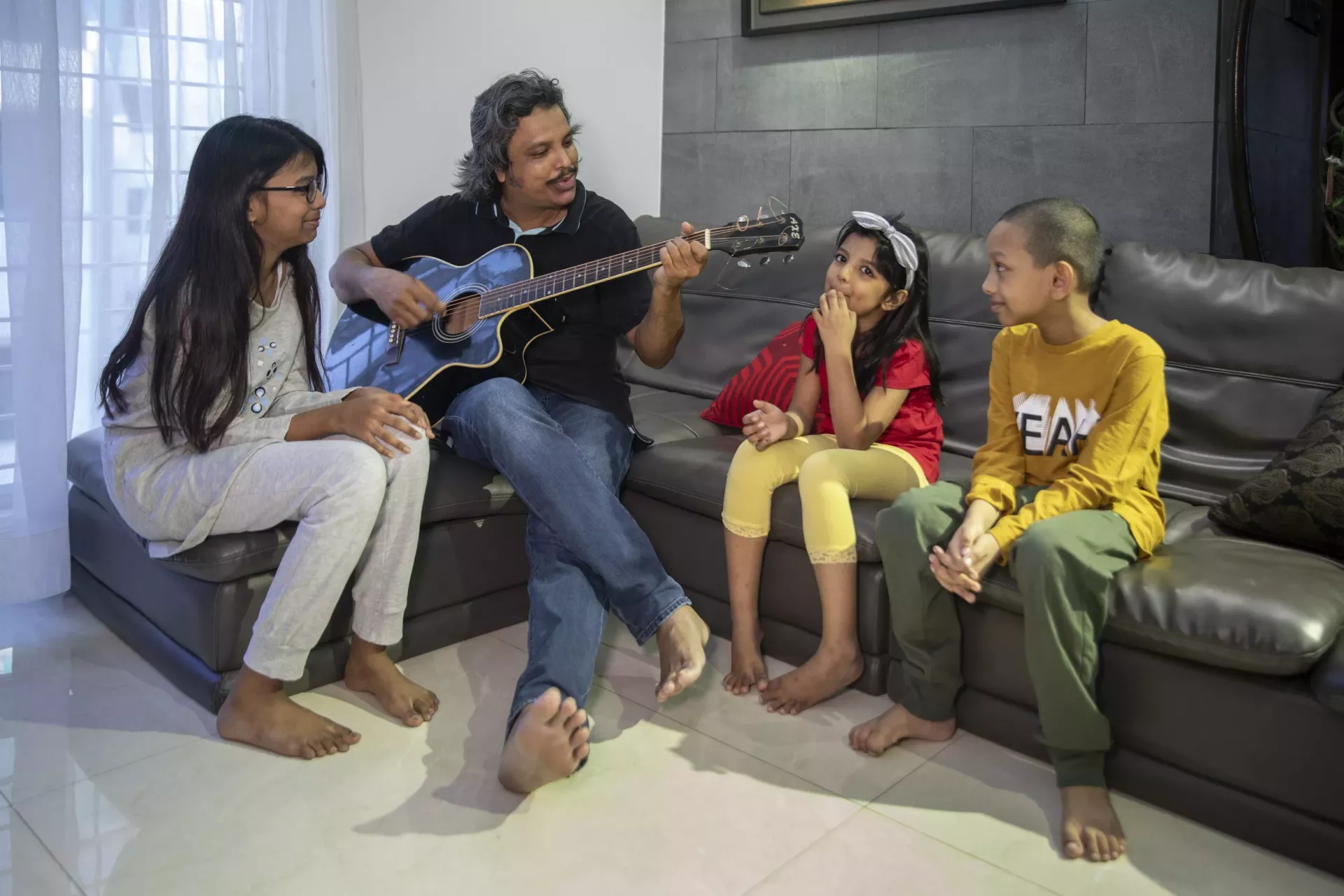 Md. Aminul Islam is singing a song to his daughters Tasneem Tabassum Soha and Nuzhat Tabassum Roza, and his nephew Raheel Hassan Aaraf . During the COVID-19 situation, he tries to engage in various activities to cheer the children as much as possible.