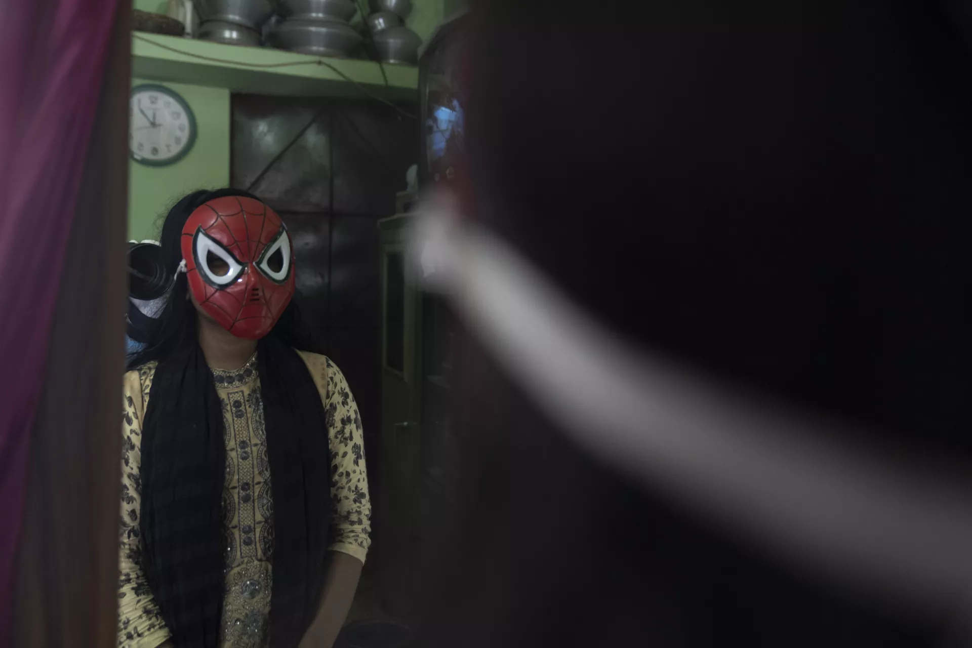 A girl wearing spider man mask 