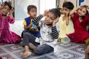 Children at the UNICEF-supported Surabari Day-care Center take part in a group learning activity through play.