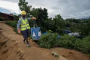Kamal carries the collected waste to the waste management facility.