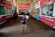 Hasib sells books and chocolate to travellers passing through the bus terminal to support his mother and younger sister.