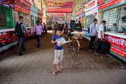 Hasib sells books and chocolate to travellers passing through the bus terminal to support his mother and younger sister.
