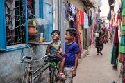 Hasib plays with his younger sister Mim in the slum neighbourhood where they now have a room of their own.