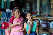 Shohana enjoys the morning ritual with her mother braiding her hair before school.
