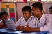Rashed (centre), 14, and his classmates receive their first-ever year-end assessment cards at a UNICEF-supported learning centre in the Rohingya refugee camps in Cox&rsquo;s Bazar, Bangladesh.