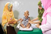 10-month-old Abu Bakkar gets his weight measured during a routine health check-up at Muradnagar Upazila Health Complex, Comilla.