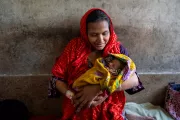 Fatema holds her baby close after a difficult forceps delivery
