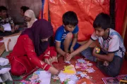 Children from the Korail slum participating in different activities at the makeshift Child Protection Community Hub, established after the original one was engulfed by the fire