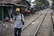 A volunteer announces the Typhoid Conjugate Vaccine (TCV) campaign in a slum area of Chattogram. ️