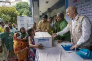 People affected by the Korail fire receiving family kits from Honourable Minister, Dr. Deepu Moni, Ministry of Social Welfare, and Mr. Sheldon Yett, Representative, UNICEF Bangladesh