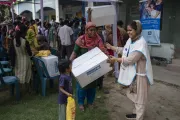 People affected by the Korail fire receiving family kits from Honourable Minister, Dr. Deepu Moni, Ministry of Social Welfare, and Mr. Sheldon Yett, Representative, UNICEF Bangladesh