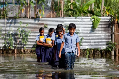 Students make their way to school after heavy floods in Sariakandi Upazila, Bogra, Bangladesh.
