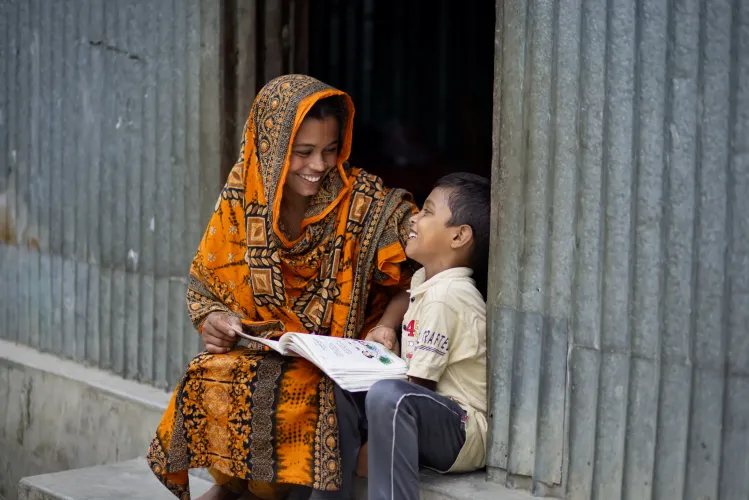 With his mother Shefali by his side, Samiul studies with encouragement and joy. 