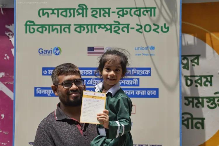 A smiling child with vaccination card