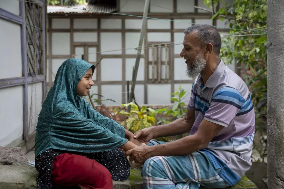 Mohiuddin plays with his older daughter Maha outside of their house. He believes that parenting improves when he actively engages in play with his children.
