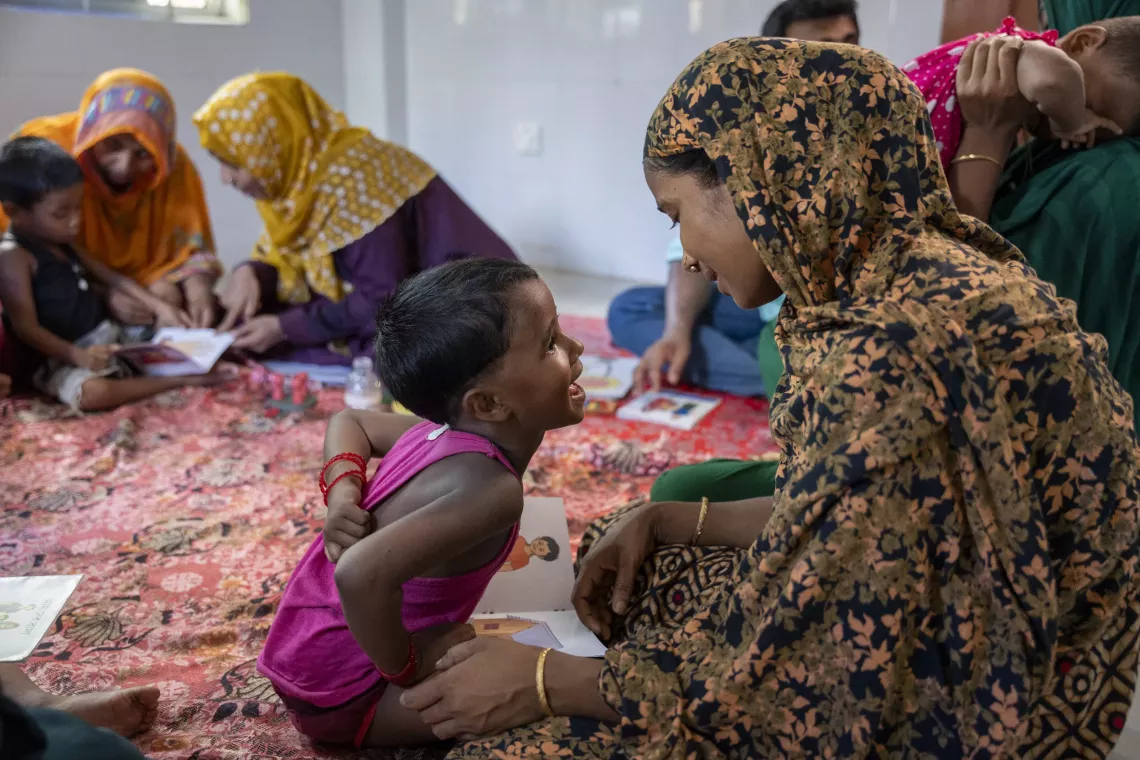 Another mother in the village, Hasna, regularly engages her daughter Jui in play-based parenting ECD session led by Prodip at the community clinic. 