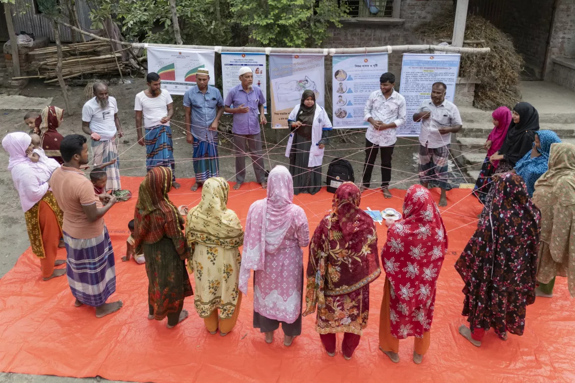 During a courtyard session, parents take part in an activity demonstrating how a child&rsquo;s brain develops during the early years of life. 