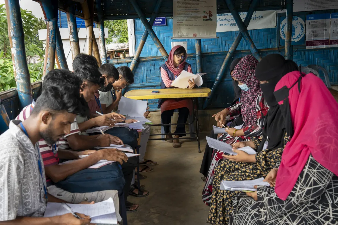 A morning briefing with nutrition volunteers takes place before they begin their daily household visits.