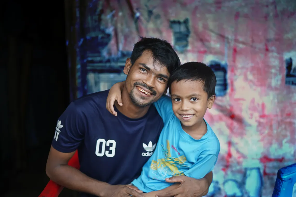 Kamal with his eldest son Mohammed Shahed (6) at home after work.