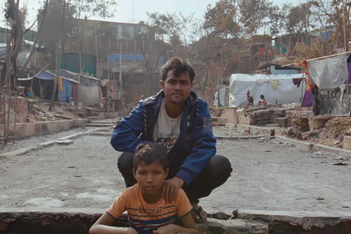 Rafik and his teacher Ekram sit where the UNICEF learning centre used to be.