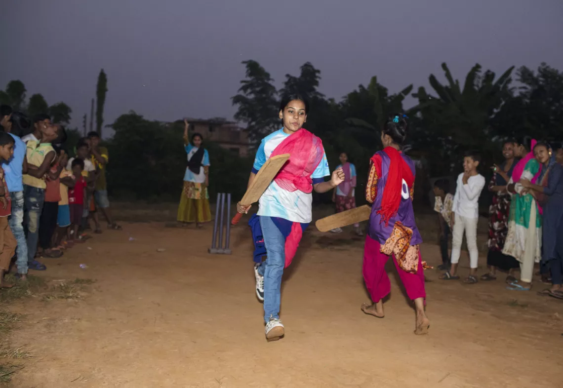 A girl playing cricket 