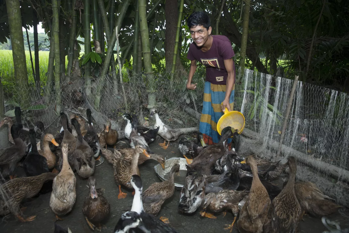 A disable boy feeding his ducks 