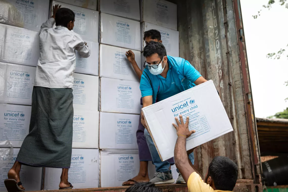 UNICEF staff prepare supplies, consisting of dignity kits and jerry cans, for dispatching to Sylhet.