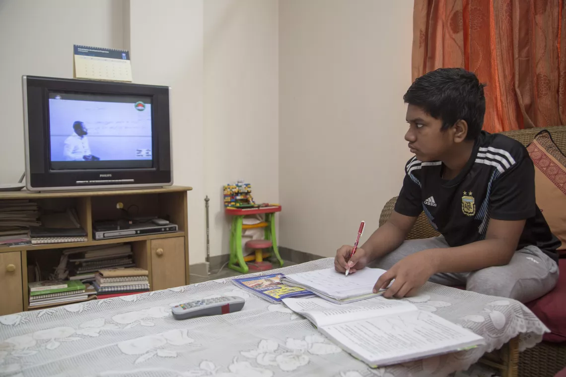 Bangladesh. Tasmid Islam, 12, is participating in online class