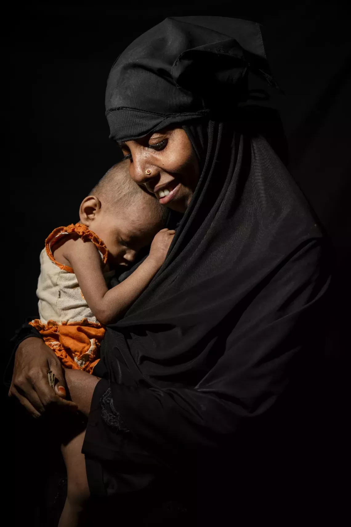 Rubeda holding Sofiba at the integrated nutrition facility. 