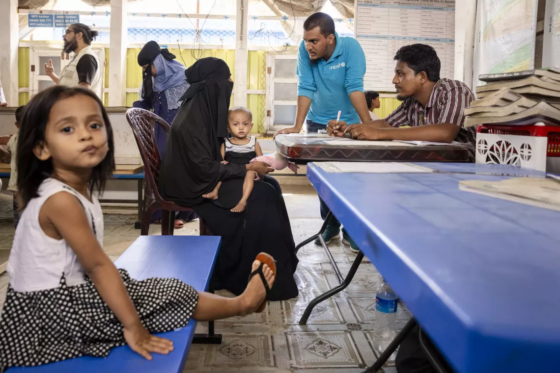 Staff explain Sofiba&rsquo;s growth chart to Rubeda during a regular check-up at the integrated nutrition facility.