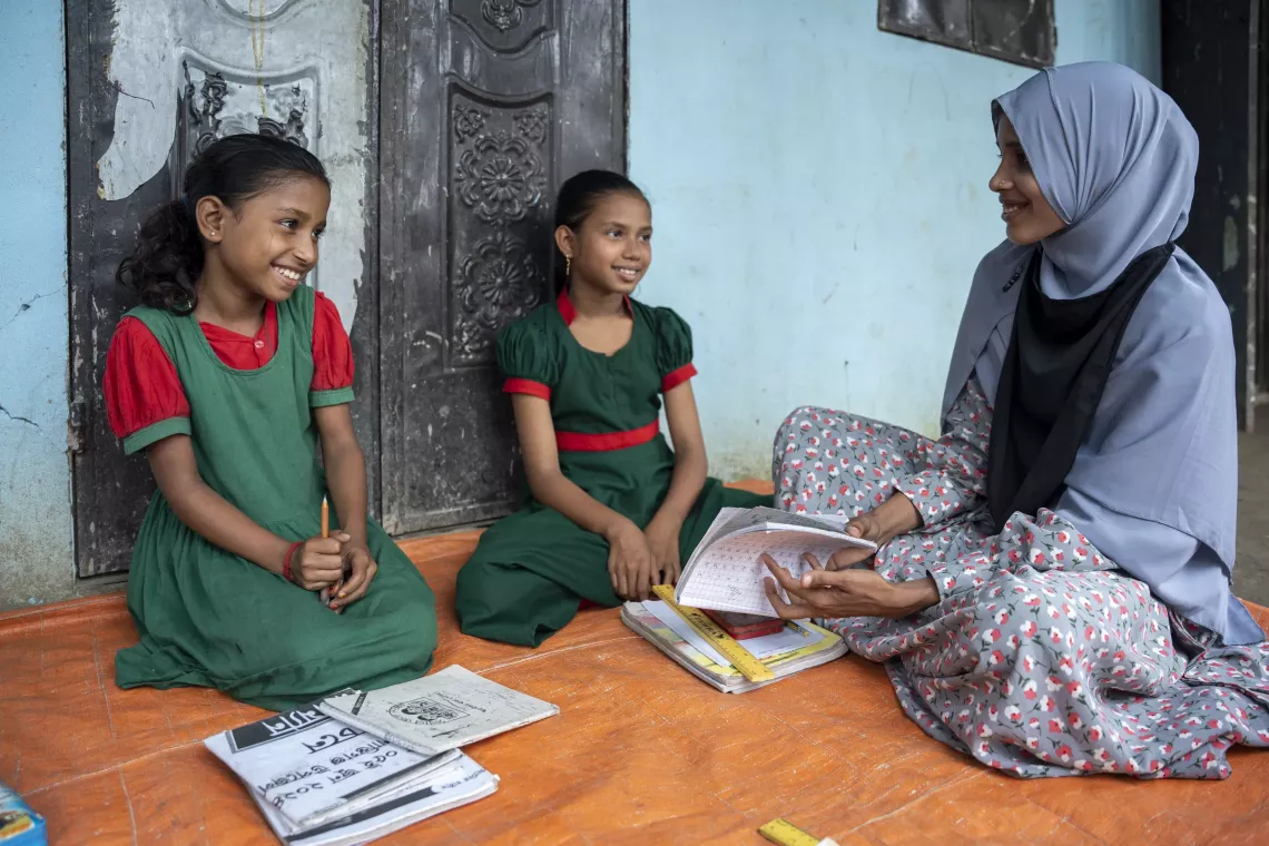 Husna (right) teaches Tawhida and Tania in class. She believes in equipping her students with storytelling and creativity skills. 