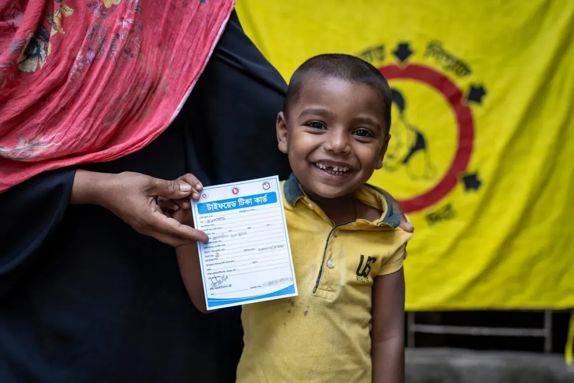 Zunayed, 5, with his vaccination card after receiving the Typhoid Conjugate Vaccine (TCV) at the city corporation ward office in Chattogram.
