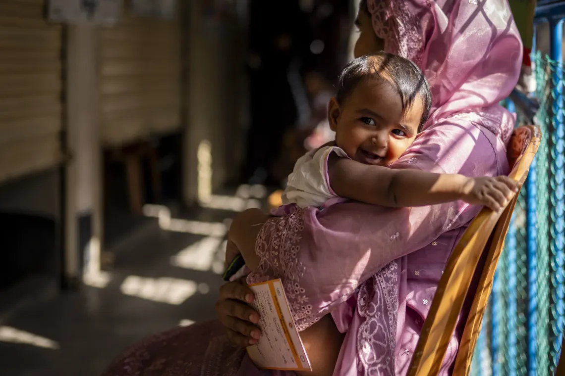 Maushami waits in line for Ayesha&rsquo;s turn to get the vaccine. 
