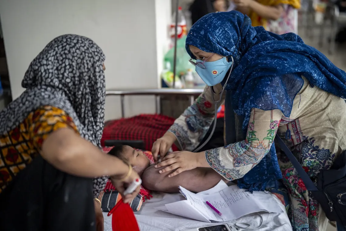 Dr. Ivey Akhter examines a child recovering from measles during a routine follow-up visit in the measles ward at Mohakhali DNCC Hospital.