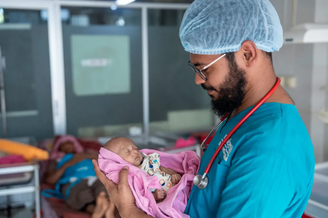 Dr. Imtiaz Hossain Sakib, a UNICEF-supported staff of the hospital holds one-month-old Sarid during a post-examination check-up at the Cox&rsquo;s Bazar District Sadar Hospital 
