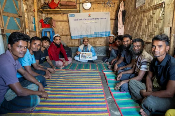 Mohammad Shahedul Mustafa, a community outreach worker, facilitates a father-to-father positive parenting session at the Rohingya refugee camps in Cox’s Bazar.