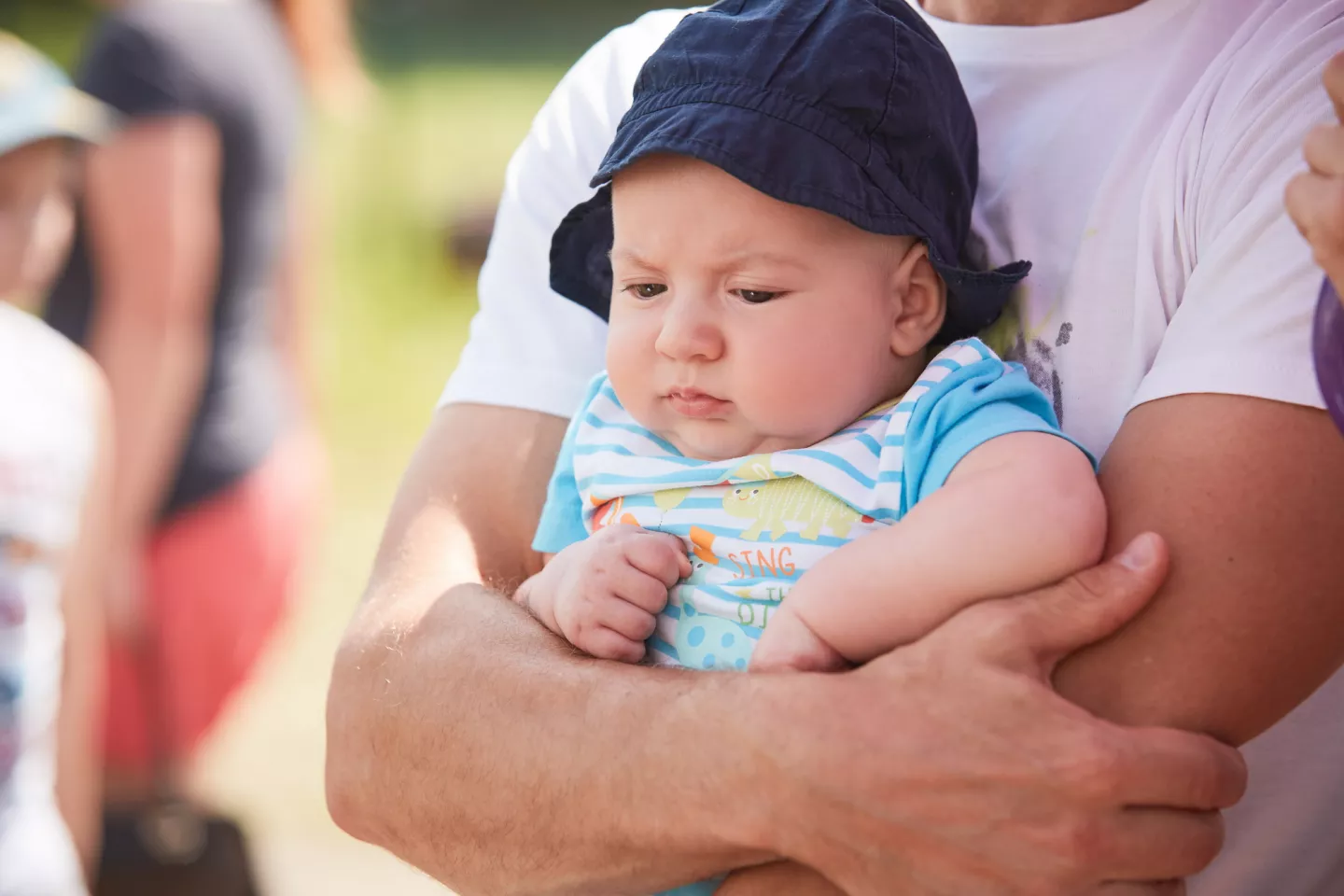 A baby embraced by his father